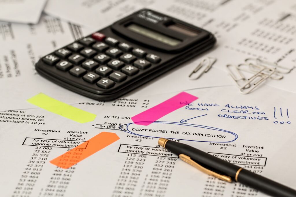 Calculator, tax documents, and financial planning for tax recruitment