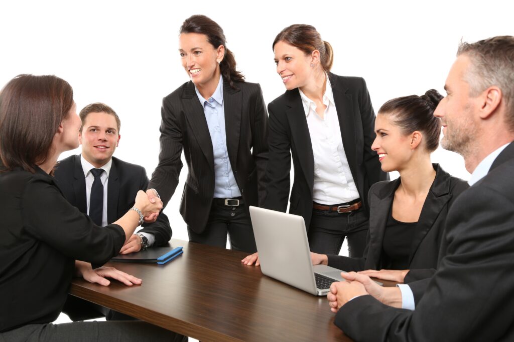 Candidate shaking hands with a hiring panel during a legal jobs interview